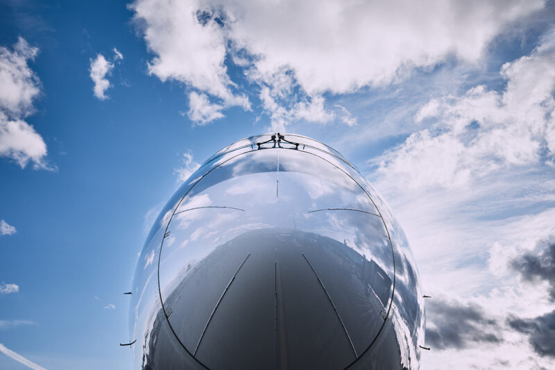 Reflection of clouds on airplane.